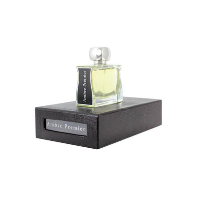 A bottle of Jovoy Ambre Premier Eau De Parfum 100ml displayed on a dark platform with the product name visible.